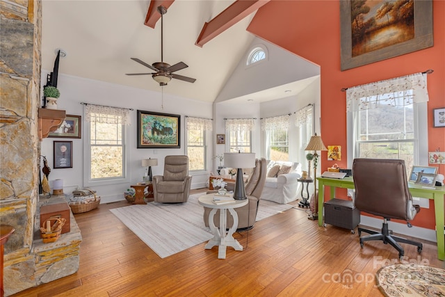 living room featuring high vaulted ceiling, a healthy amount of sunlight, and hardwood / wood-style flooring