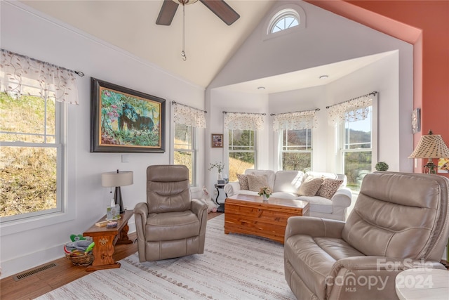 living room with light wood-type flooring, ceiling fan, and lofted ceiling