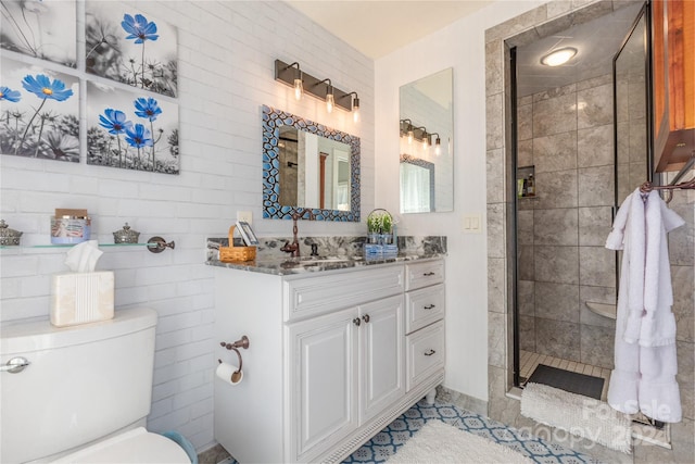 bathroom with vanity, toilet, tile patterned floors, and walk in shower