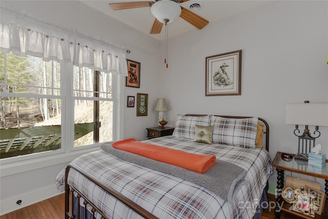 bedroom with ceiling fan and wood-type flooring