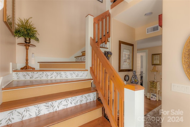 stairs with hardwood / wood-style flooring