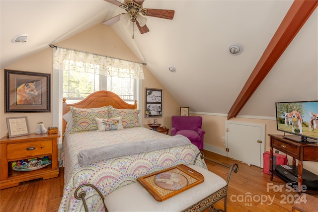 bedroom with ceiling fan, light wood-type flooring, and vaulted ceiling