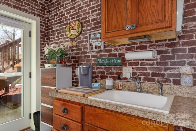 interior space with brick wall and sink