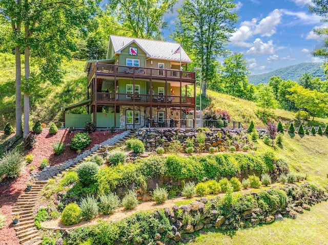 back of property featuring a deck with mountain view