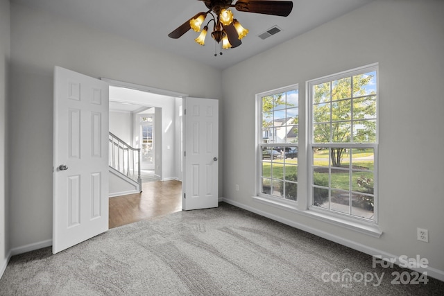 carpeted empty room with ceiling fan