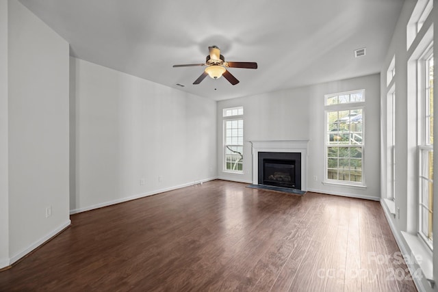 unfurnished living room featuring dark hardwood / wood-style flooring and ceiling fan