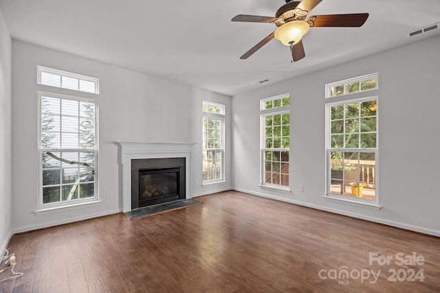 unfurnished living room featuring ceiling fan and dark hardwood / wood-style flooring