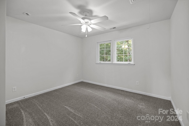 carpeted spare room with ceiling fan