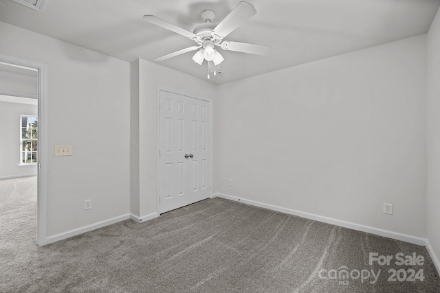 empty room with carpet and ceiling fan