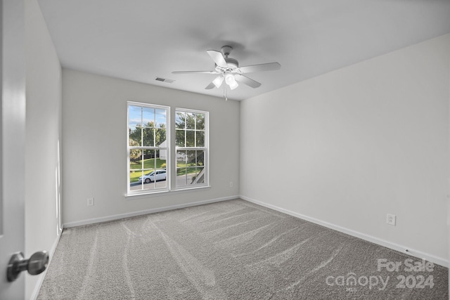 spare room featuring ceiling fan and light colored carpet