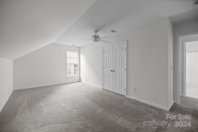 bonus room featuring ceiling fan, vaulted ceiling, and carpet