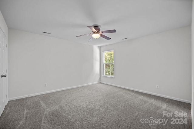 empty room featuring ceiling fan and carpet floors