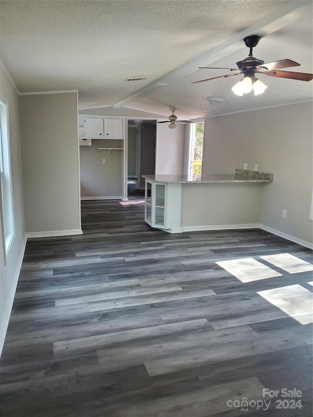 unfurnished room with ceiling fan, ornamental molding, dark hardwood / wood-style floors, and a textured ceiling