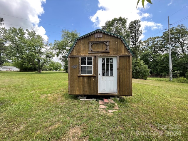 view of outdoor structure featuring a lawn