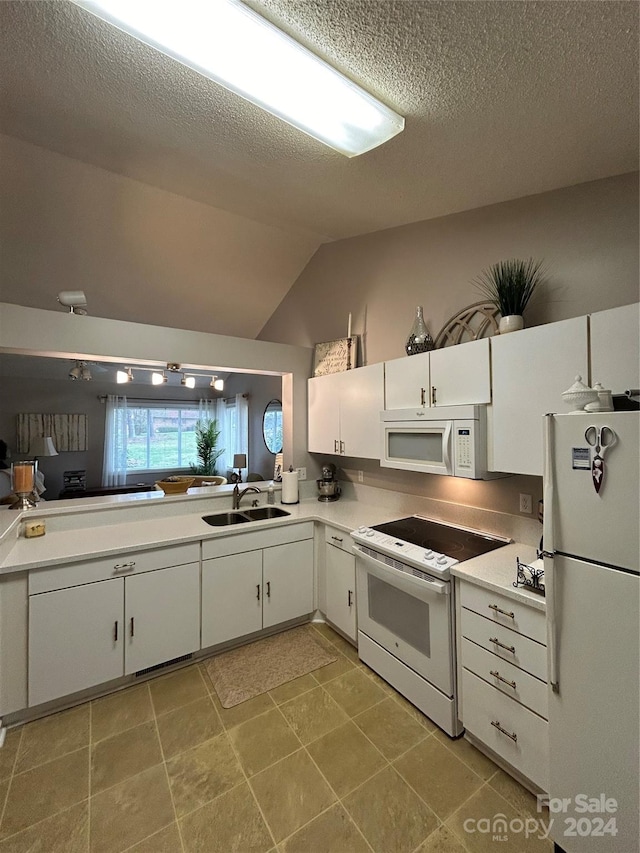 kitchen with white cabinets, lofted ceiling, white appliances, and sink