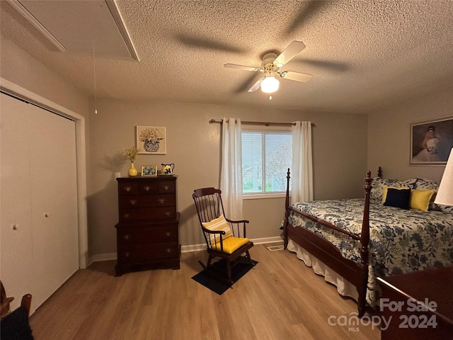 bedroom featuring ceiling fan, light wood-type flooring, and a closet