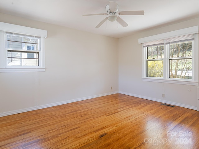 unfurnished room with ceiling fan and light hardwood / wood-style flooring