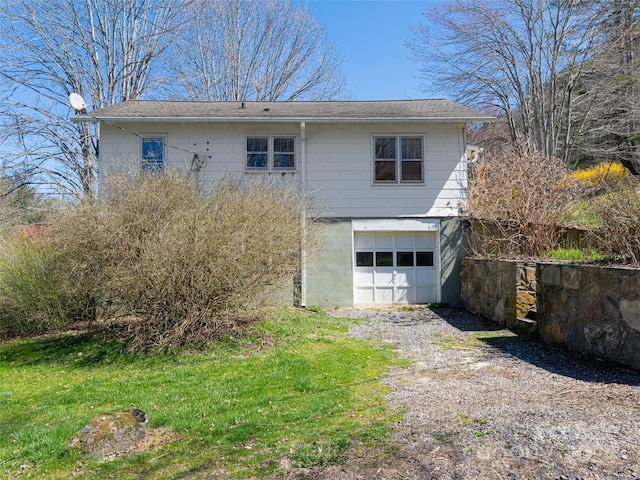 back of property featuring a garage