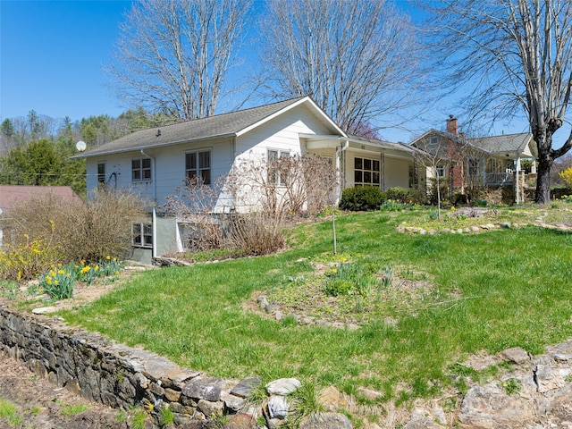 rear view of property featuring a yard