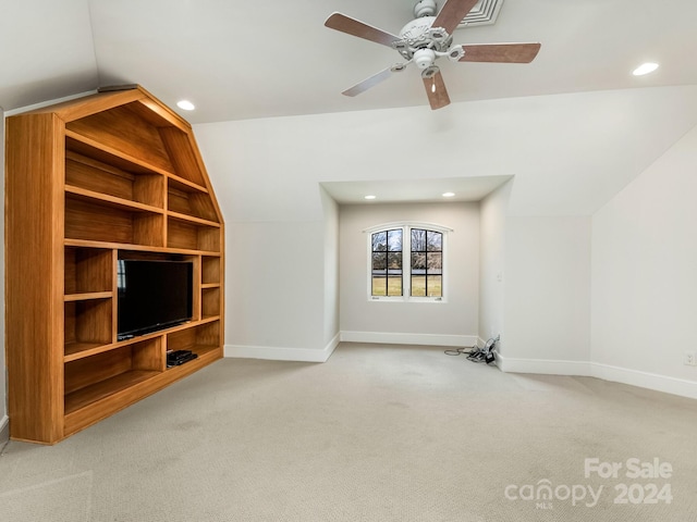 unfurnished living room with lofted ceiling, light colored carpet, and ceiling fan