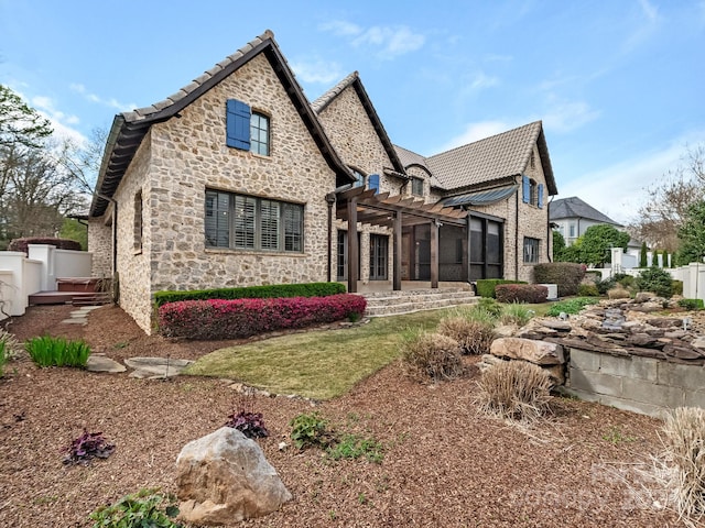 back of property featuring a pergola