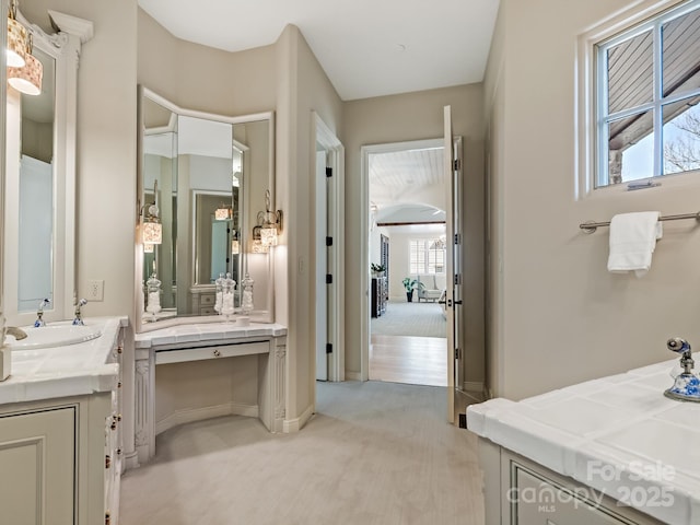 bathroom with two vanities and a sink