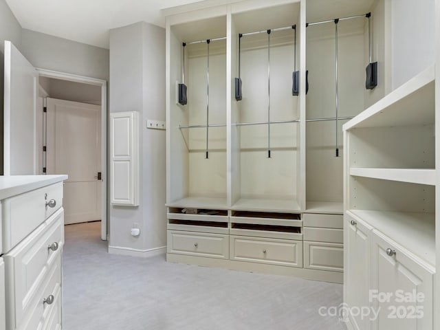 mudroom featuring light carpet and baseboards