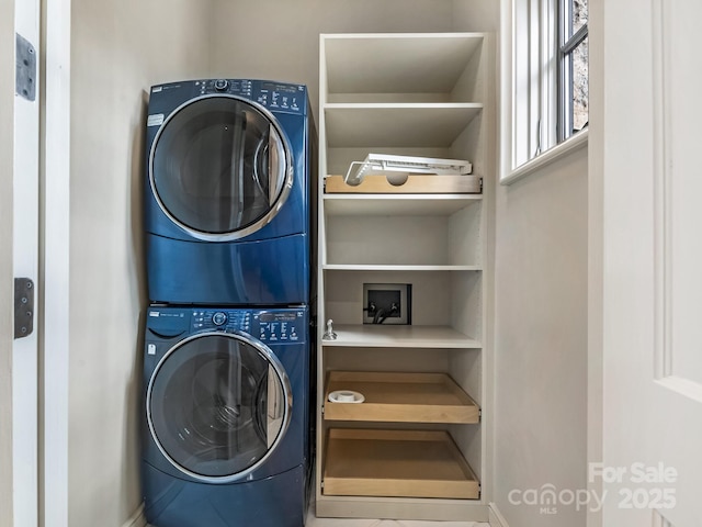 clothes washing area featuring stacked washer and dryer