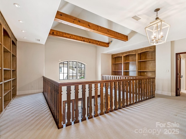 corridor featuring light carpet, visible vents, baseboards, and an inviting chandelier