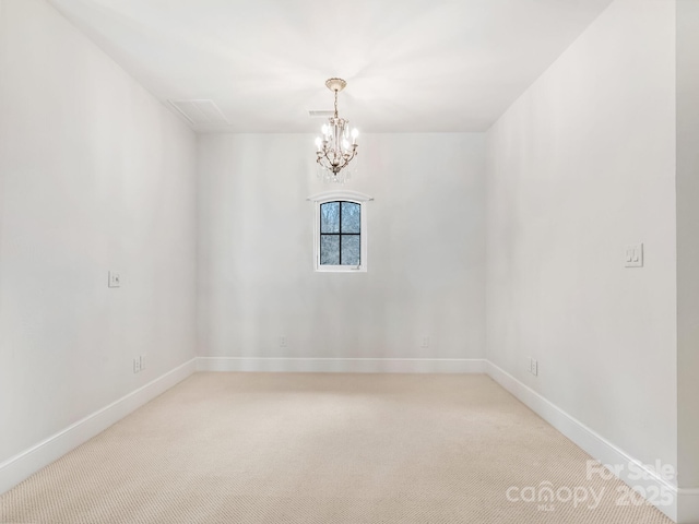 spare room with light carpet, an inviting chandelier, and baseboards