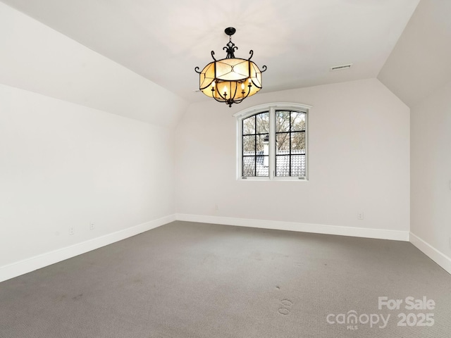 bonus room featuring vaulted ceiling, an inviting chandelier, visible vents, and baseboards