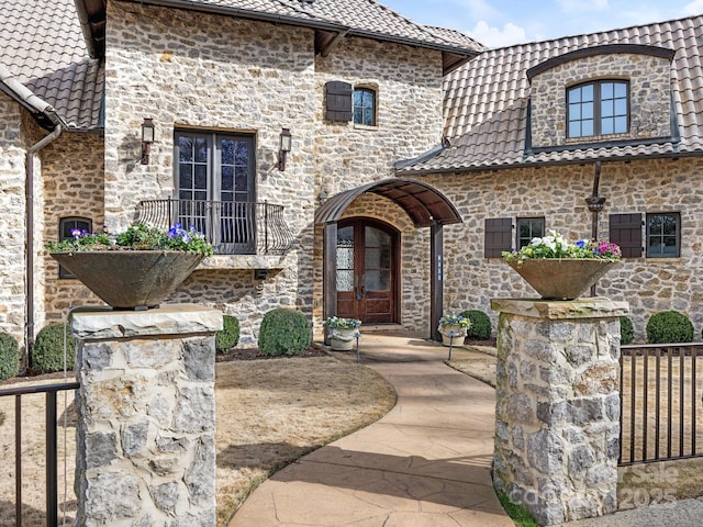 view of front facade featuring french doors and a tile roof