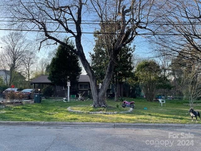 obstructed view of property featuring a front yard