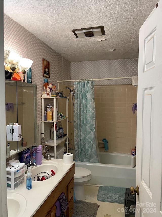 full bathroom with tile flooring, double vanity, a textured ceiling, shower / tub combo, and toilet