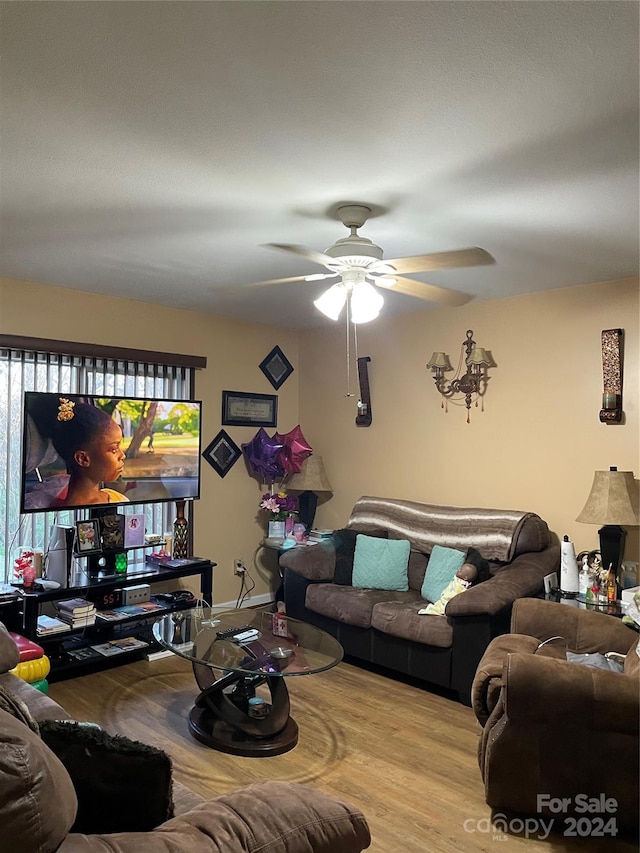 living room featuring ceiling fan and light wood-type flooring