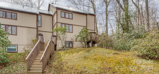 rear view of property featuring a lawn