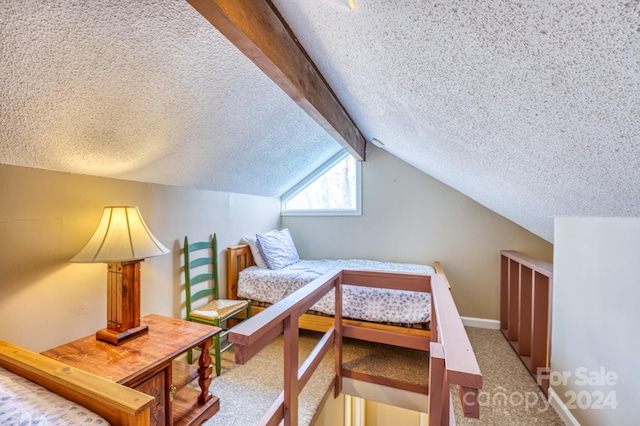 bedroom featuring a textured ceiling, carpet flooring, and lofted ceiling with beams