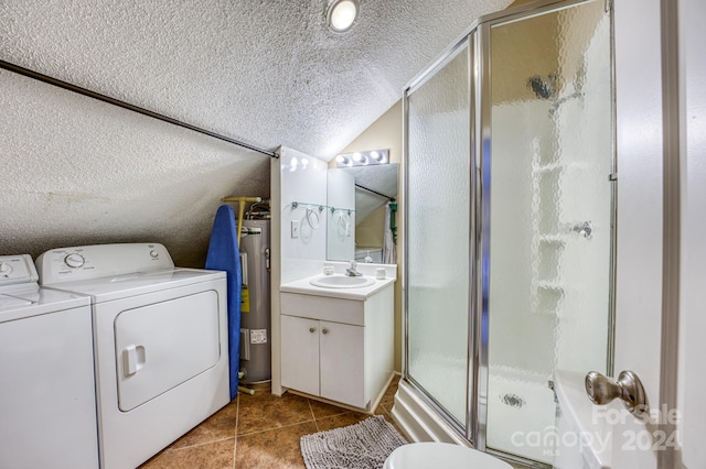 interior space featuring a textured ceiling, vanity with extensive cabinet space, water heater, a shower with shower door, and washing machine and clothes dryer