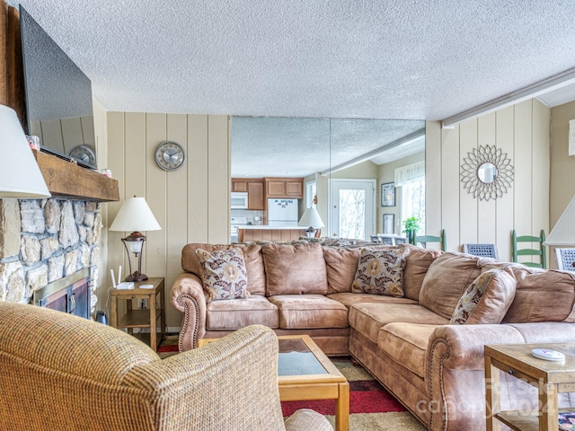 carpeted living room with a fireplace and a textured ceiling