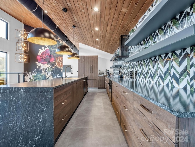 kitchen with a kitchen island with sink, sink, wood ceiling, wall chimney range hood, and decorative light fixtures