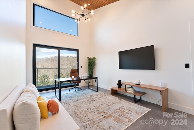 carpeted living room with a towering ceiling, a chandelier, and wooden ceiling