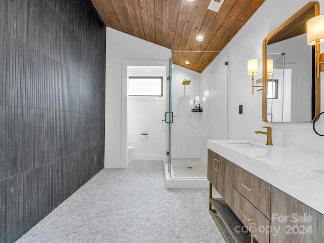 bathroom featuring toilet, wood ceiling, tile floors, and vanity with extensive cabinet space