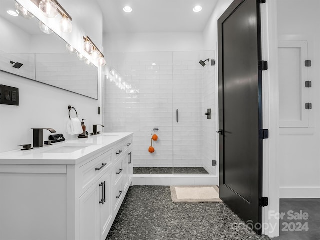 bathroom with tile floors, dual vanity, and walk in shower