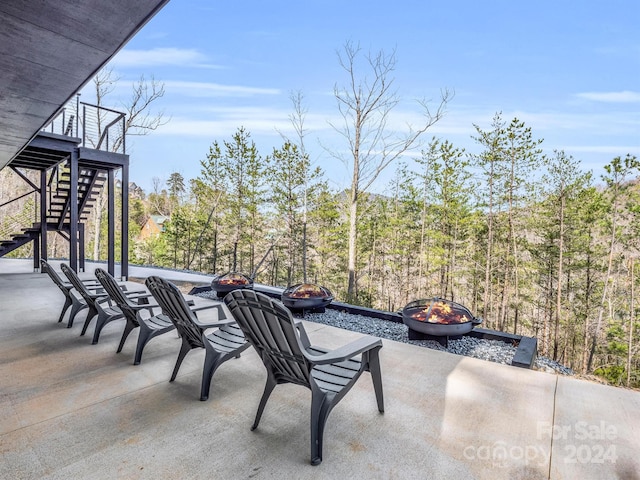 view of terrace featuring an outdoor fire pit