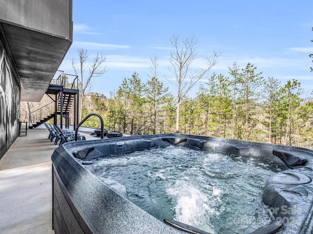 view of pool with a hot tub