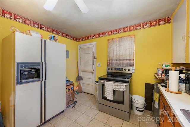 kitchen featuring ceiling fan, stainless steel electric stove, white fridge with ice dispenser, and light tile floors