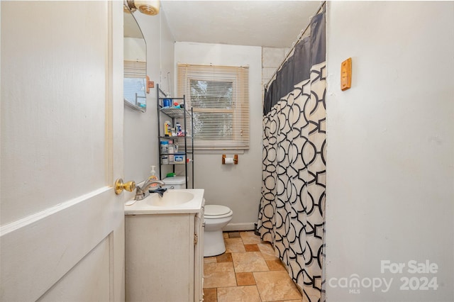 bathroom with vanity, tile floors, and toilet