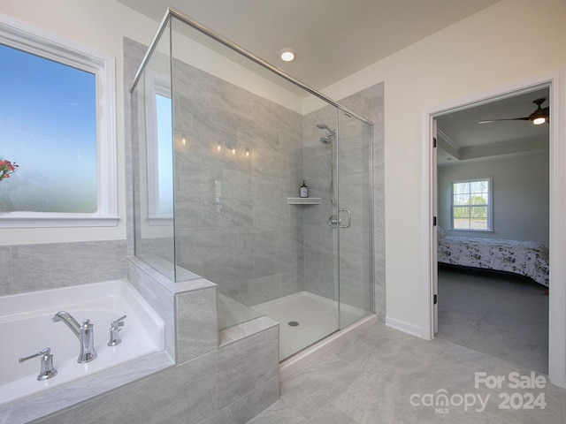 bathroom featuring ceiling fan and separate shower and tub