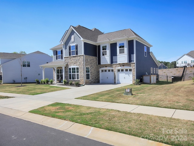 view of front of property with a garage and a front lawn