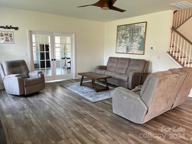 living room featuring french doors, ceiling fan, and dark hardwood / wood-style flooring